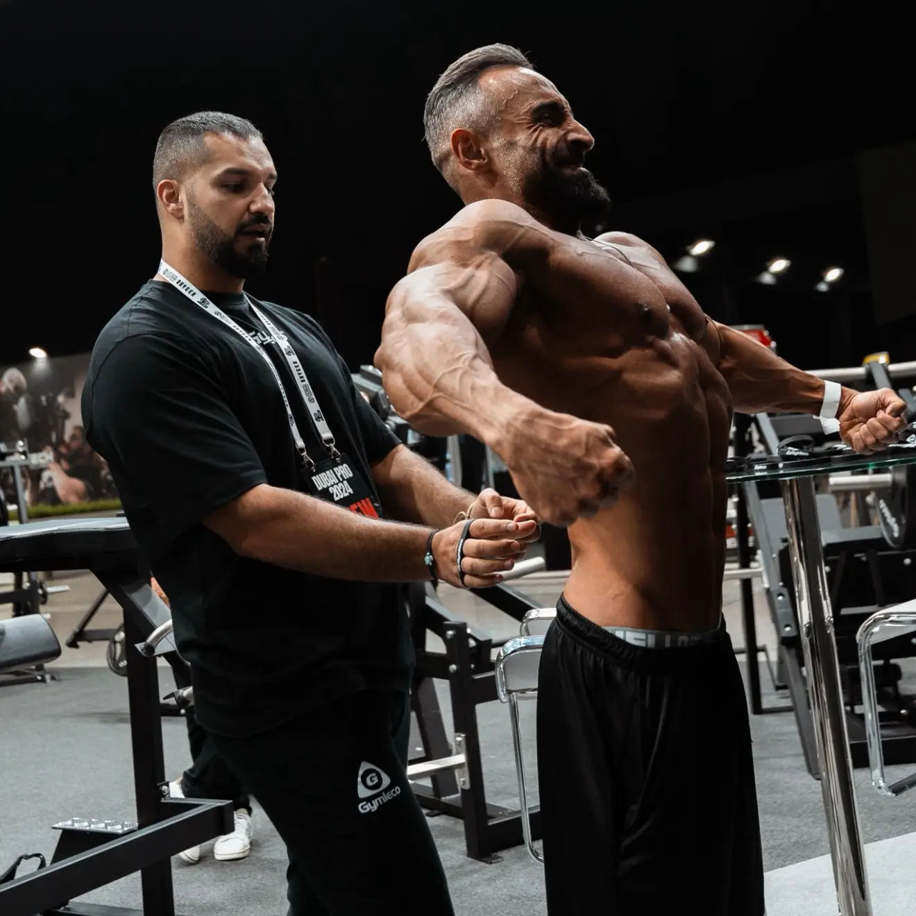 Coach Saad with client doing a flex pose