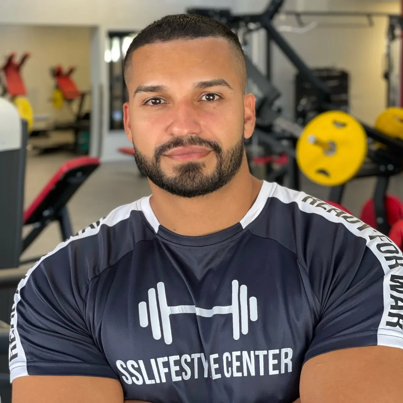 Portrait of coach Saad smiling in gym